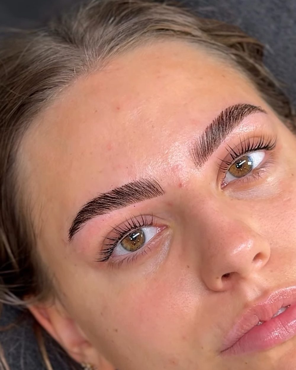 Lash lift and tint — close-up of lifted, tinted lashes with laminated brows